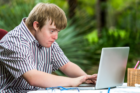 man with disability working on a laptop