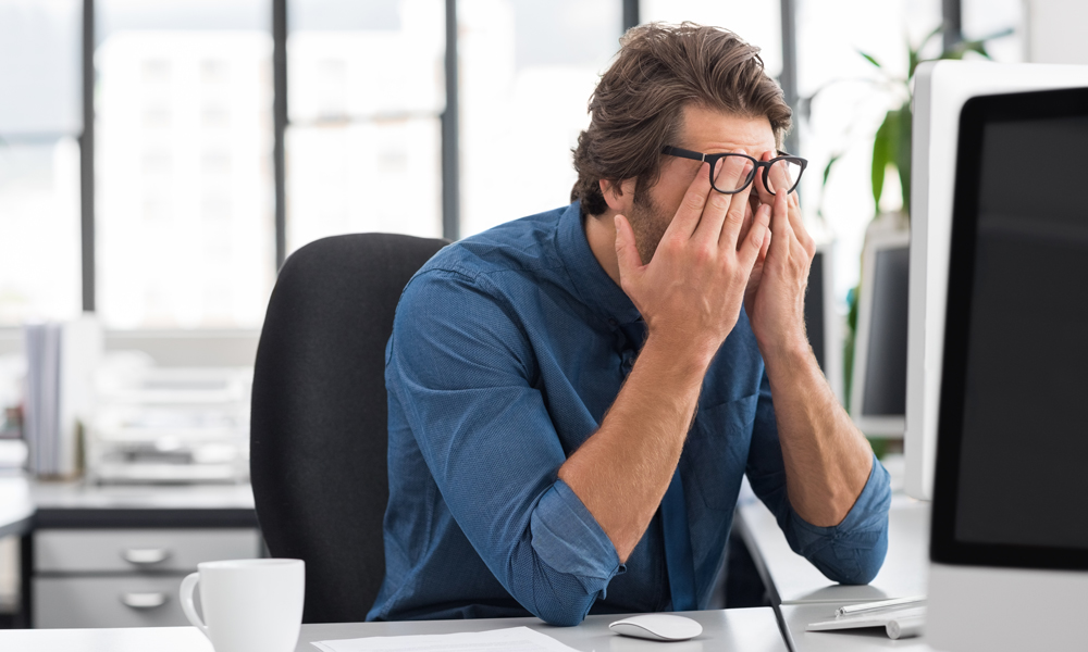 Man frustrated by something on his computer screen